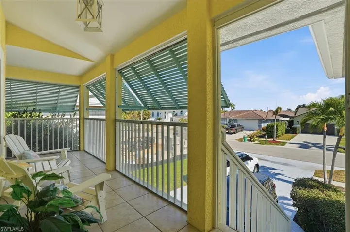Covered porch featuring a residential view
