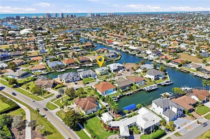 View of property location featuring a nearby body of water and nearby suburban area