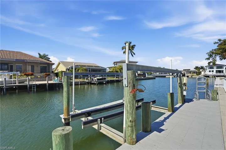 Dock featuring boat lift and a water view