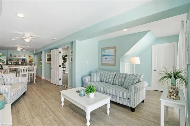 Living area with ceiling fan, light wood-type flooring, and recessed lighting