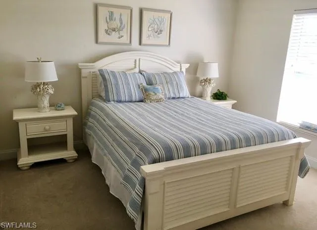 Carpeted bedroom featuring baseboards