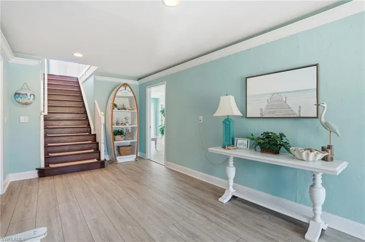 Entryway with crown molding, light wood finished floors, and recessed lighting