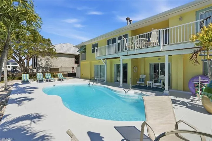 Swimming pool featuring a patio and a balcony