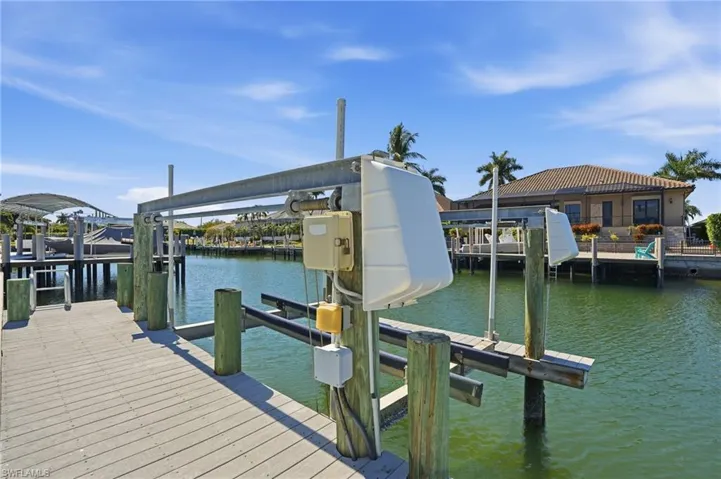 Dock with boat lift and a water view