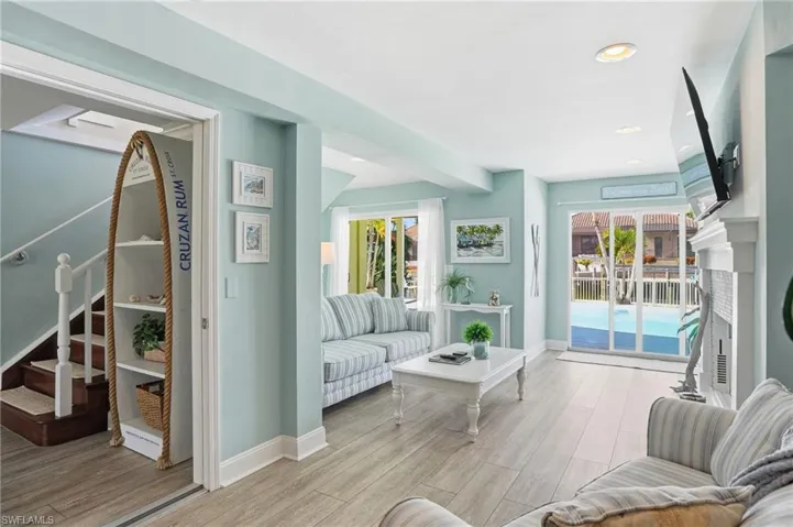Living area featuring light wood-style floors, recessed lighting, and a fireplace