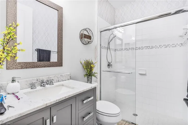 Bathroom with a stall shower and vanity