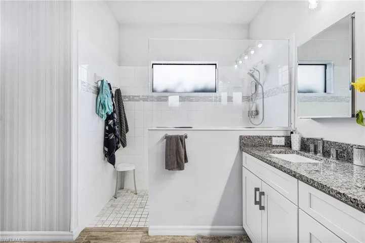 Bathroom with vanity and a walk in shower
