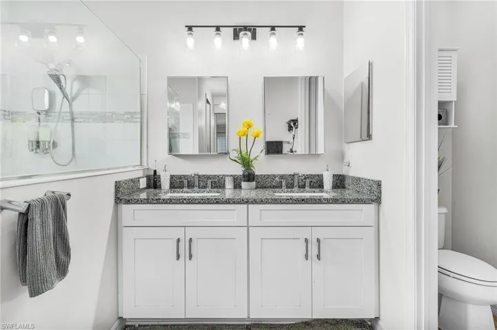 Full bath with double vanity and toilet