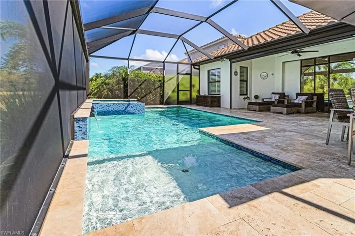 View of swimming pool featuring a patio, ceiling fan, a pool with connected hot tub, and an outdoor living space