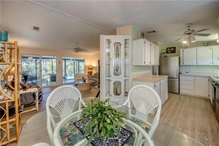 Dining space featuring ceiling fan, light hardwood / wood-style floors, and a textured ceiling