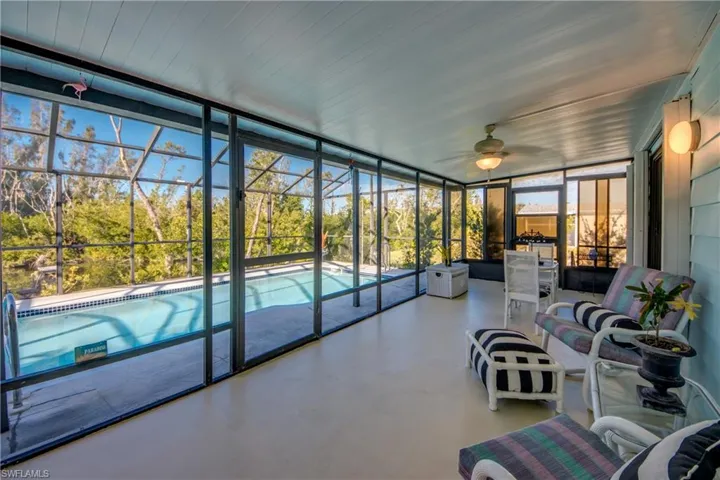 Sunroom / solarium featuring ceiling fan