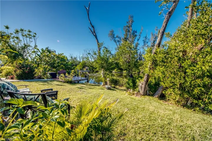 View of yard featuring a boat dock and a water view