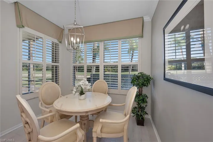 Dining room with a chandelier, plenty of natural light, and crown molding