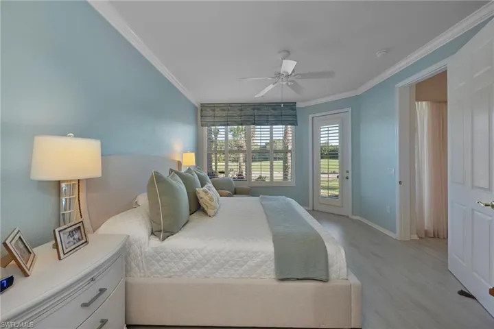 Bedroom featuring access to exterior, light wood-type flooring, crown molding, and ceiling fan