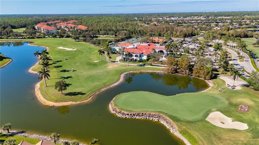 Aerial view of residential area with a large body of water and a golf club