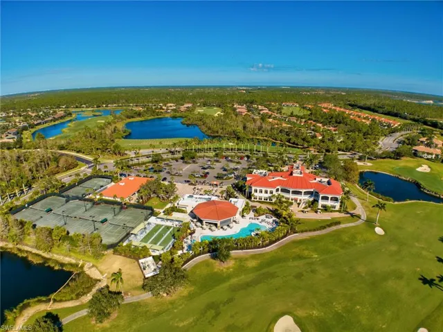 Aerial view of property's location featuring a large body of water and a local golf course