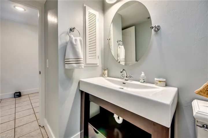 Bathroom featuring toilet, tile floors, and large vanity
