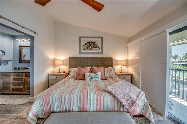 Bedroom featuring access to outside, lofted ceiling, ceiling fan, and hardwood / wood-style floors