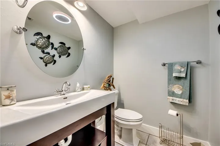 Bathroom featuring tile floors, vanity, and toilet