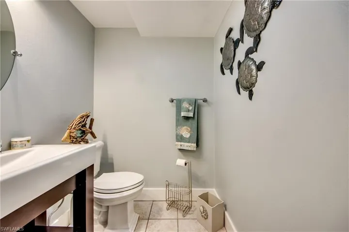 Bathroom with tile flooring, vanity, and toilet