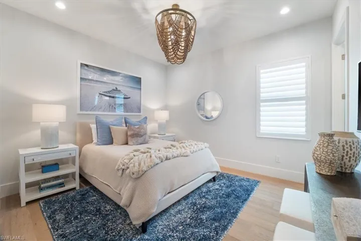 Bedroom featuring a chandelier and light hardwood / wood-style flooring