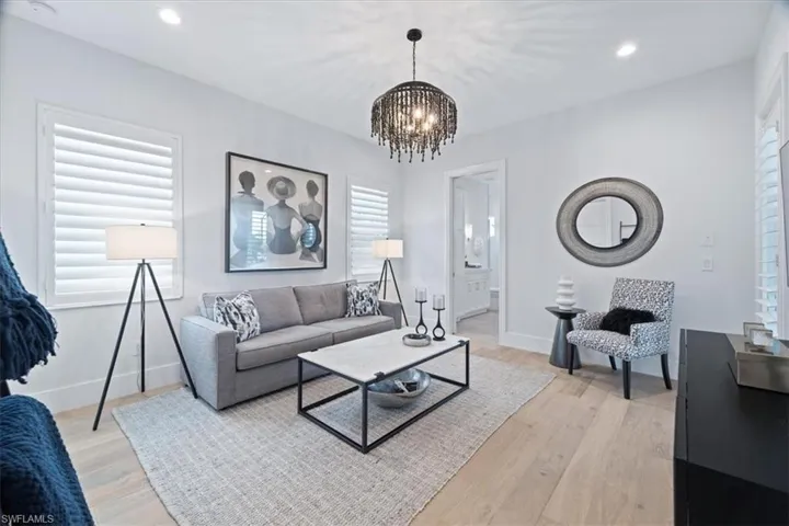 Living room featuring light hardwood / wood-style floors and an inviting chandelier