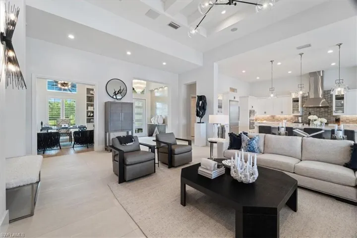 Living room featuring light tile patterned floors and a high ceiling