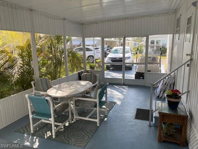 Sunroom / solarium with outdoor dining space