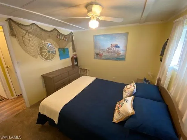 Bedroom featuring ceiling fan and carpet