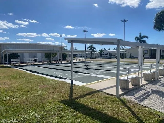 View of community featuring shuffleboard and a patio