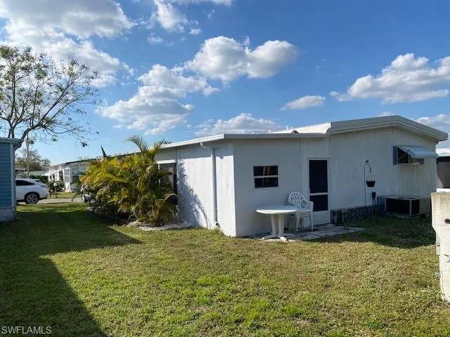 Rear view of house with a yard