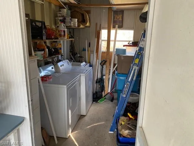 Laundry area featuring separate washer and dryer and concrete flooring