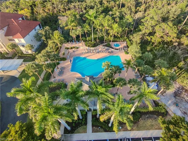 Aerial view of property and surrounding area featuring a pool area