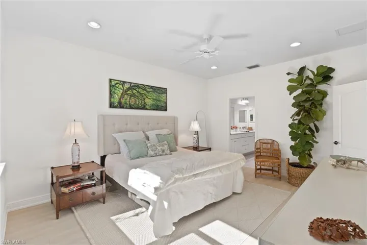 Bedroom with a ceiling fan, ensuite bath, recessed lighting, and light wood-style floors