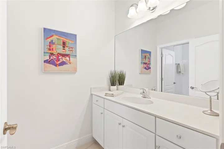 Bathroom featuring vanity and baseboards