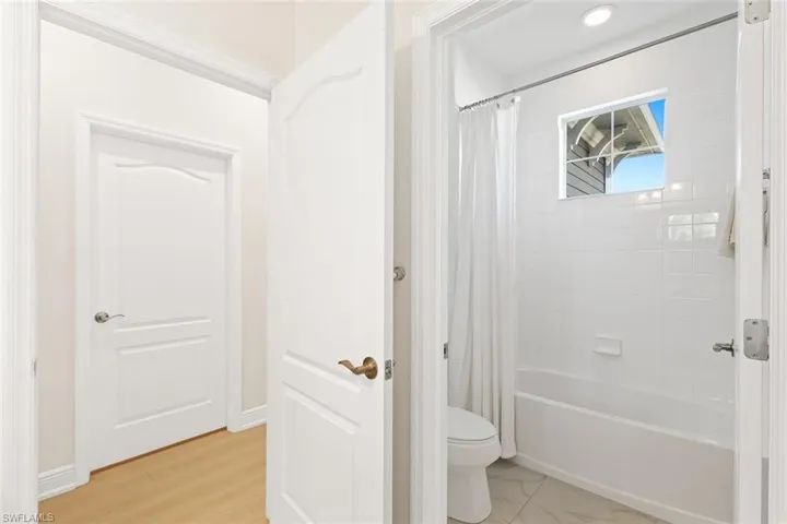 Full bath with shower / bath combination with curtain and toilet