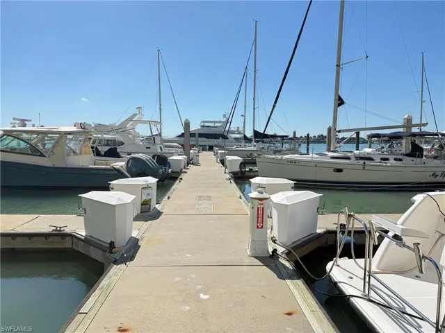 Concrete dock featuring multiple boat slips, marine pedestals, and water access