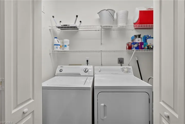 Dedicated laundry area featuring a white top-load washer and a white front-load dryer
