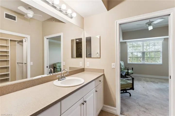 Bathroom with vanity and ceiling fan