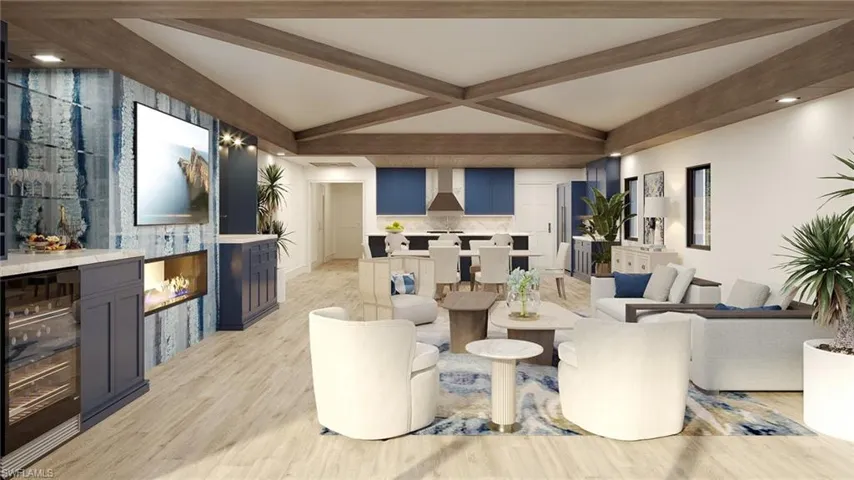 Living room with vaulted ceiling with beams, a fireplace, light hardwood / wood-style floors, and beverage cooler