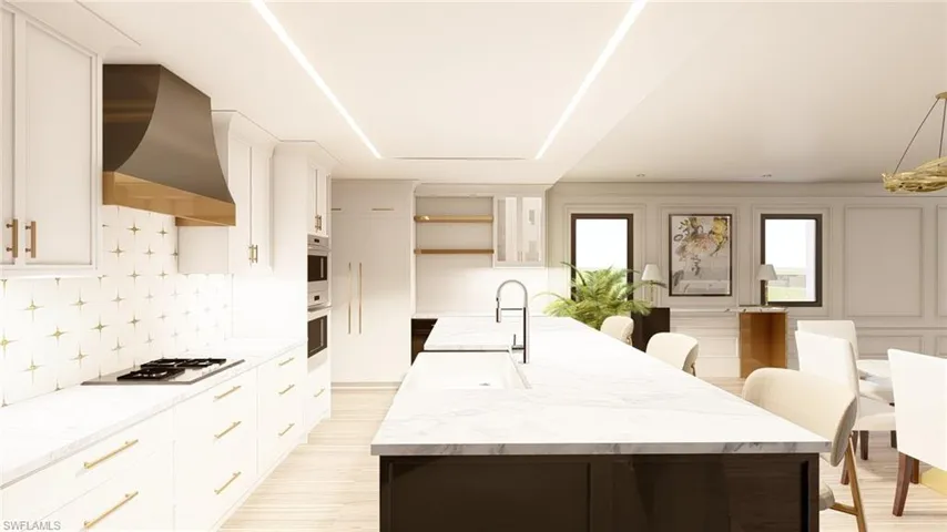 Kitchen with wall chimney exhaust hood, appliances with stainless steel finishes, and a kitchen island with sink