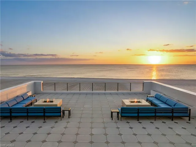 Patio terrace at dusk featuring a water view and an outdoor hangout area