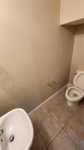 Bathroom with tile patterned flooring and toilet