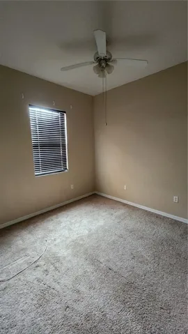 Spare room with carpet floors and ceiling fan