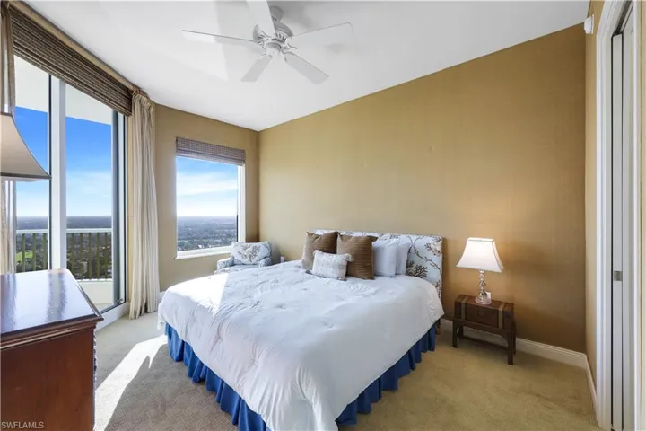 Carpeted bedroom with ceiling fan