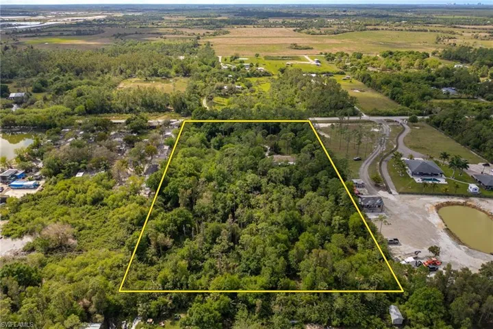 Birds eye view of property with a forest view