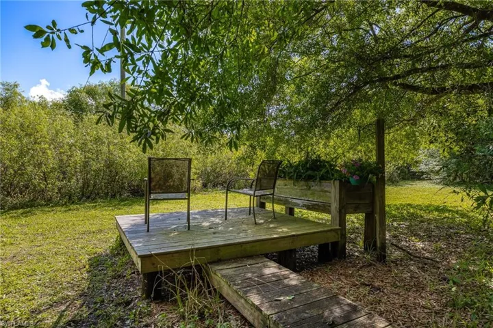 View of property's community featuring a deck and a lawn