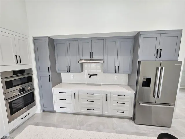 Custom kitchen with many drawers and high end Bosch stainless steel appliances