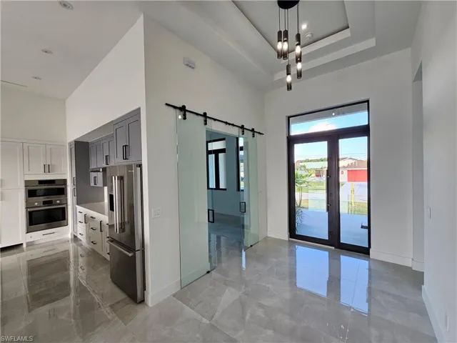 Foyer, double glass barn doors towards den
