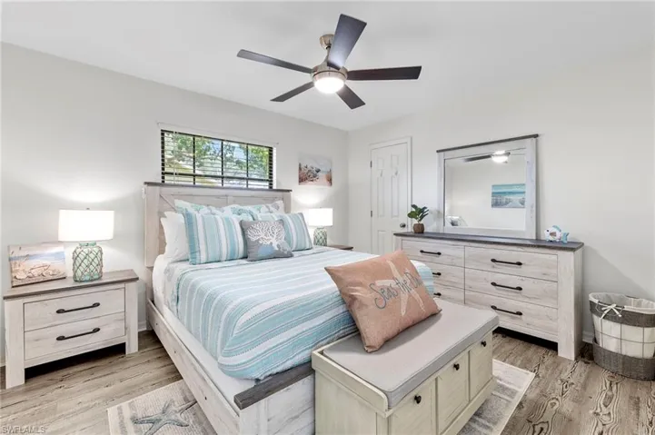 Bedroom with ceiling fan and light hardwood / wood-style flooring
